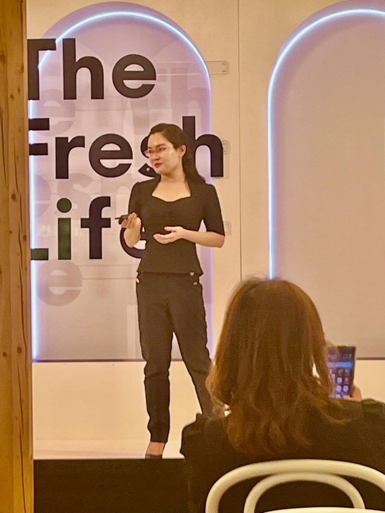 Dr Jing Wang on stage speaking at aesthetic conference Sydney